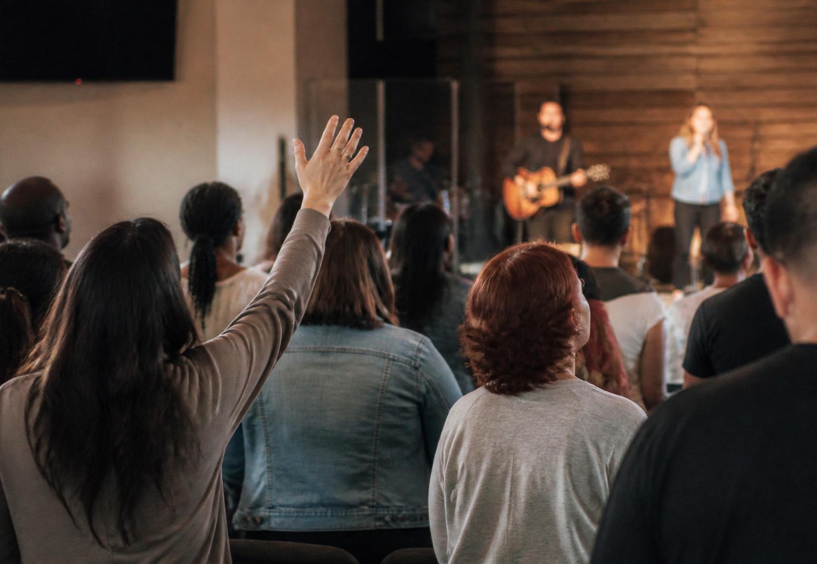 A Pentecostal congregation lifting their hands in worship.
